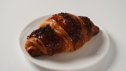 Traditional French breakfast croissant with chocolate on white background