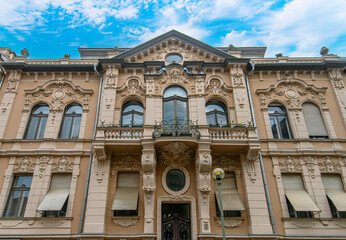 Front view the facade of beautiful old building with old sculptures in the city center of Szeged, Hungary