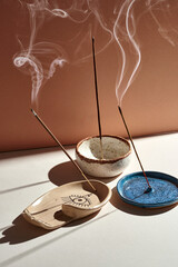 A set of burning incense for yoga or meditation. Minimalistic concept with warm colors