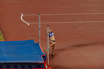 high jump female athlete in athletics competition