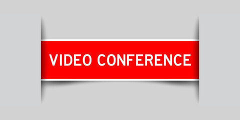 Inserted red color label sticker with word video conference on gray background