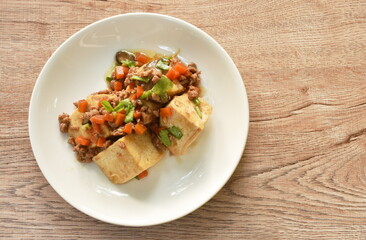 steamed white tofu topping mashed pork and vegetable gravy sauce on plate