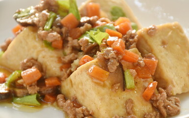 steamed white tofu topping mashed pork and vegetable gravy sauce on plate