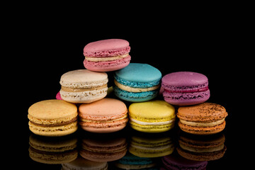 Colorful macaroon over black background