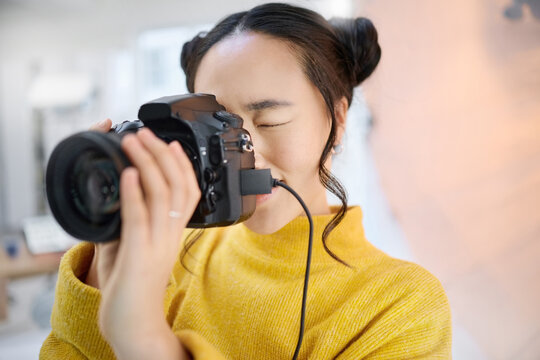photography, camera and woman in studio shooting creative memory picture, photoshoot or digital production. Lens focus, art creativity and young Japanese photographer girl working for artistic shot