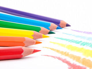 Photography of color pencils isolated on white background with rainbow colours applied on paper