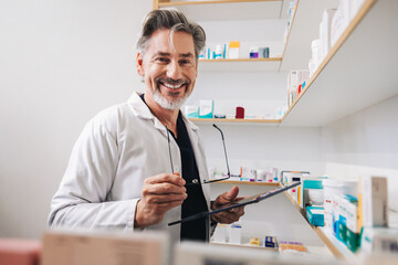 Senior pharmacist standing in a chemist