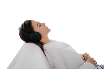 Young student caucasian girl in white shirt and headphones on her head, relaxing on sofa at home eyes closed, listening music, prepares to exams. Young calm woman sleeps against transparent background