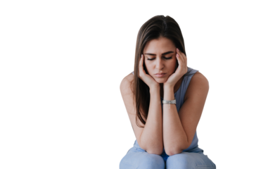 Frustrated young hispanic woman sitting against transparent background looks down, tired. Beautiful Spanish girl feels fatigue, female in troubles, failure. Upset housewife, divorce, feels loneliness.