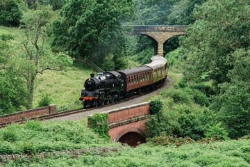 Steam train Locomotive travelling along the track on the North Yorkshire Moors Railway