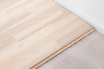 Naklejka na ściany i meble Laminate click floor edge - new parquet flooring indoors - close up