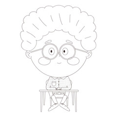 schoolboy sitting at a desk with his hands folded