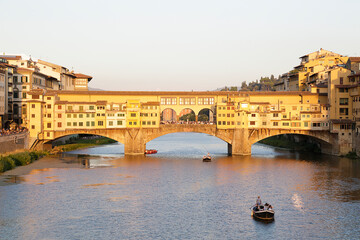 Fototapeta na wymiar Ponte Vecchio with river Arno at sunset in Florence, Italy