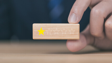 Customer review experience Dissatisfied Choosing 1 star review on wooden block