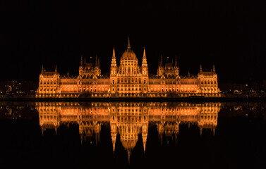 Fototapeta na wymiar Panoramic of the Parliament of Budapest (Hungary) and its reflection, night photography, from the river.