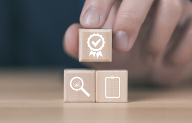 Wooden block showing best quality assurance service symbol	
