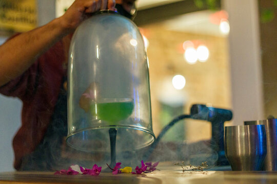 Person Pouring Cocktail Into Glass