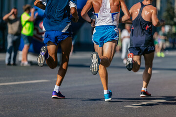 back three athletes runners run city marathon