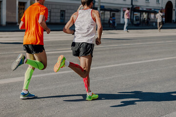 Fototapeta na wymiar two male runners athletes leaders of marathon race