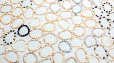 Natural sea pearls. A bunch of pearls on a white background, pearl strands close-up.