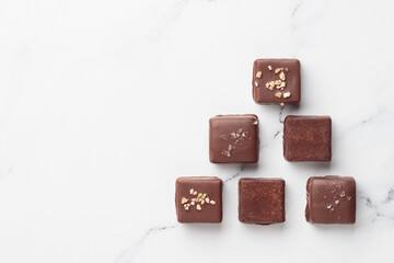 Chocolate bonbons on white marble background