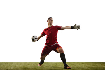 Young caucasian football player, male soccer goalkeeper wearing red football kit isolated over...