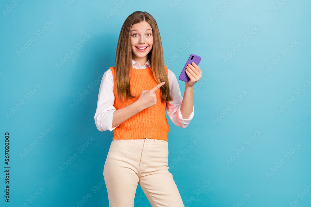 Canvas Prints Photo of charming cute girl indicate finger telephone offer promotion isolated on blue color background