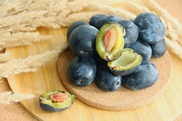 fresh plum on wooden background