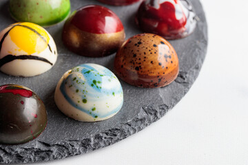 Assortment of painted handcrafted chocolate bonbons. Delicious dessert