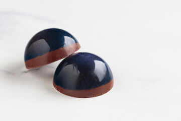 Painted handcrafted chocolate bonbons. Delicious dessert