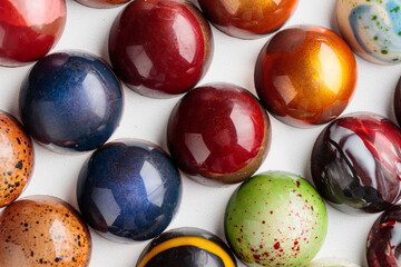 Assortment of painted handcrafted chocolate bonbons. Delicious dessert