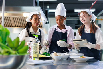 take note on book. Cooking class. culinary classroom. group of happy young woman multi-ethnic...