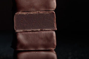 Chocolate bonbons with truffla on black background