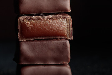 Chocolate bonbons with praline on black background