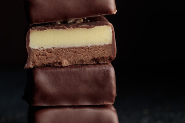 Chocolate bonbons with praline on black background