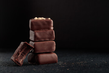 Chocolate bonbons with praline on black background