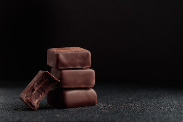 Chocolate bonbons with praline on black background