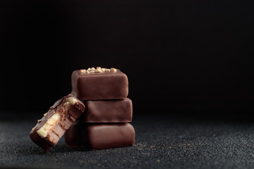 Chocolate bonbons with praline on black background