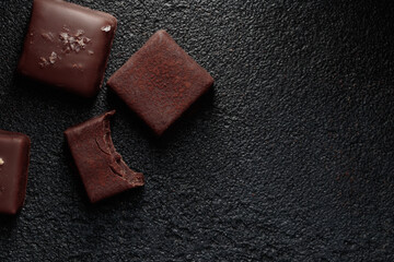 Chocolate bonbons with truffle on black background
