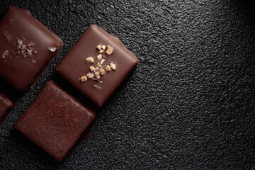 Chocolate bonbons with praline on black background