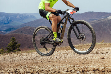 Fototapeta na wymiar athlete cyclist riding uphill on mountain bike