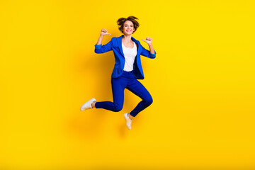 Fototapeta na wymiar Full length photo of cool confident woman wear blue jumping high pointing thumbs herself isolated yellow color background
