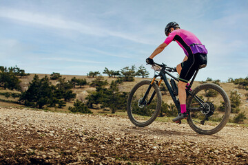 Fototapeta na wymiar male cyclist biking mountain bike uphill