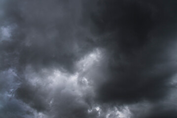 Dramatic dark storm rain clouds black sky background. Dark thunderstorm clouds rainny atmosphere. Meteorology danger windstorm disasters climate. Dark cloudscape storm disaster gloomy gray cloud sky