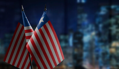 Small flags of the Liberia on an abstract blurry background