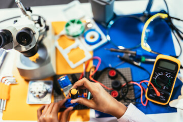 Smart Young African American Schoolgirl is Studying Electronics in Her Science Hobby Robotics Project. Girl is Working on a Robot in Her Room. Education Concept.