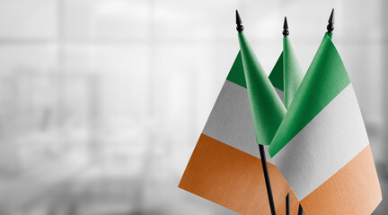 Small flags of the Ireland on an abstract blurry background