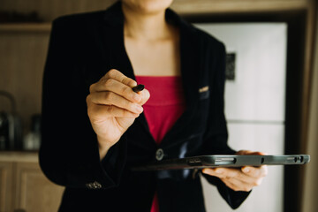 Mature businessman using a digital tablet to discuss information with a younger colleague in a modern business lounge