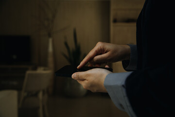 Mature businessman using a digital tablet to discuss information with a younger colleague in a modern business lounge