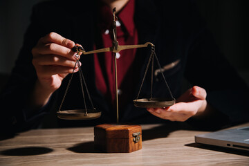 Justice and law concept.Male judge in a courtroom with the gavel, working with, computer and...